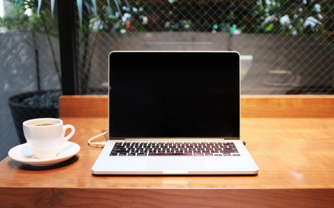 laptop and a coffee cup on a desk