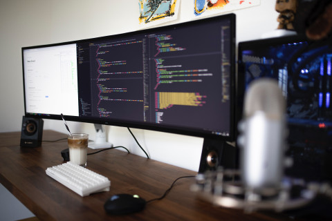 three monitors on a desk