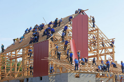 lots of builders working on a house together