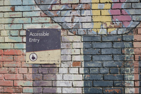 Accessible Entry sign on brick wall